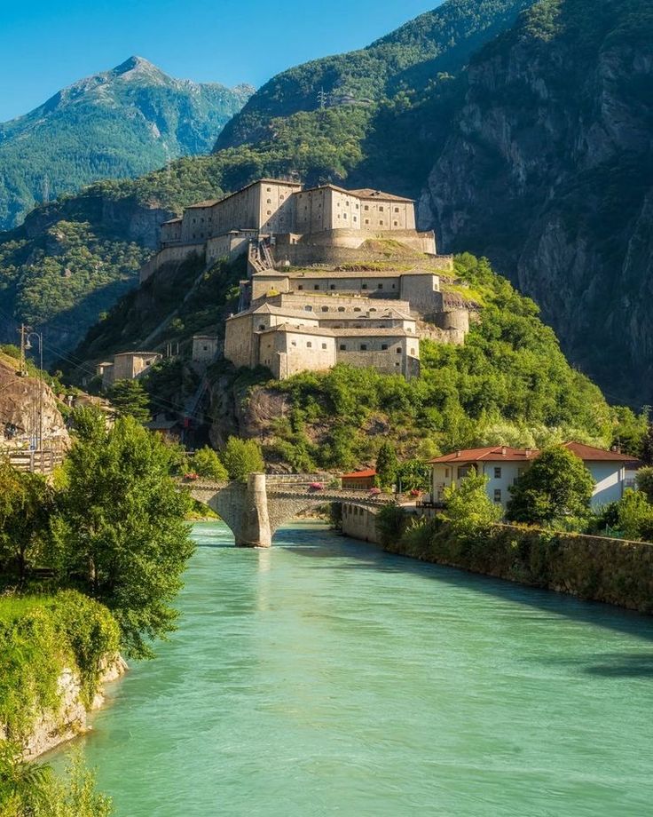 The Roman triumphal arch of Aosta with the snow-capped Alps in the background — the ancient capital of the Aosta Valley