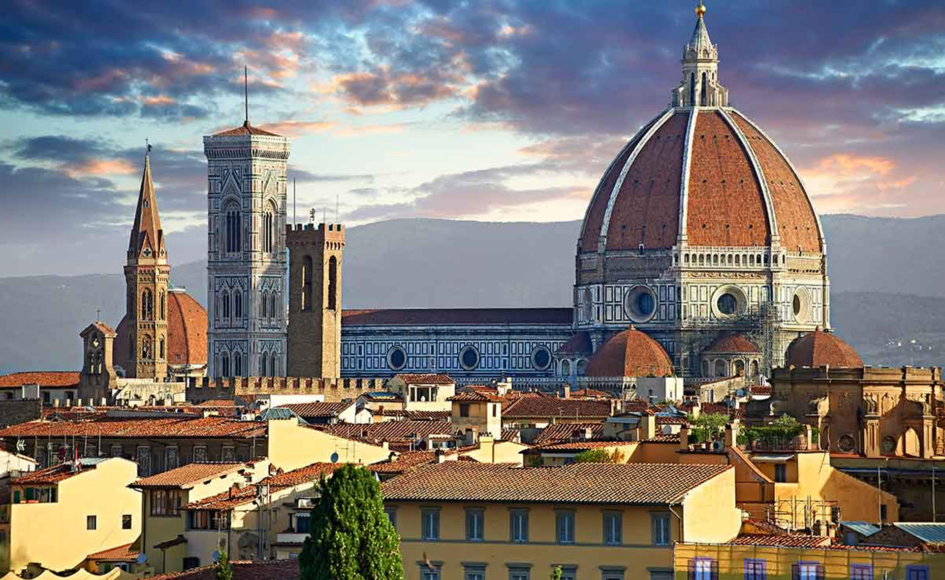 The Florence skyline at golden hour — the Duomo and Brunelleschi's dome seen from Piazzale Michelangelo