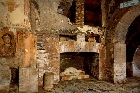 Interior of the Roman Catacombs showing ancient burial niches and early Christian decorations carved into the tufa rock